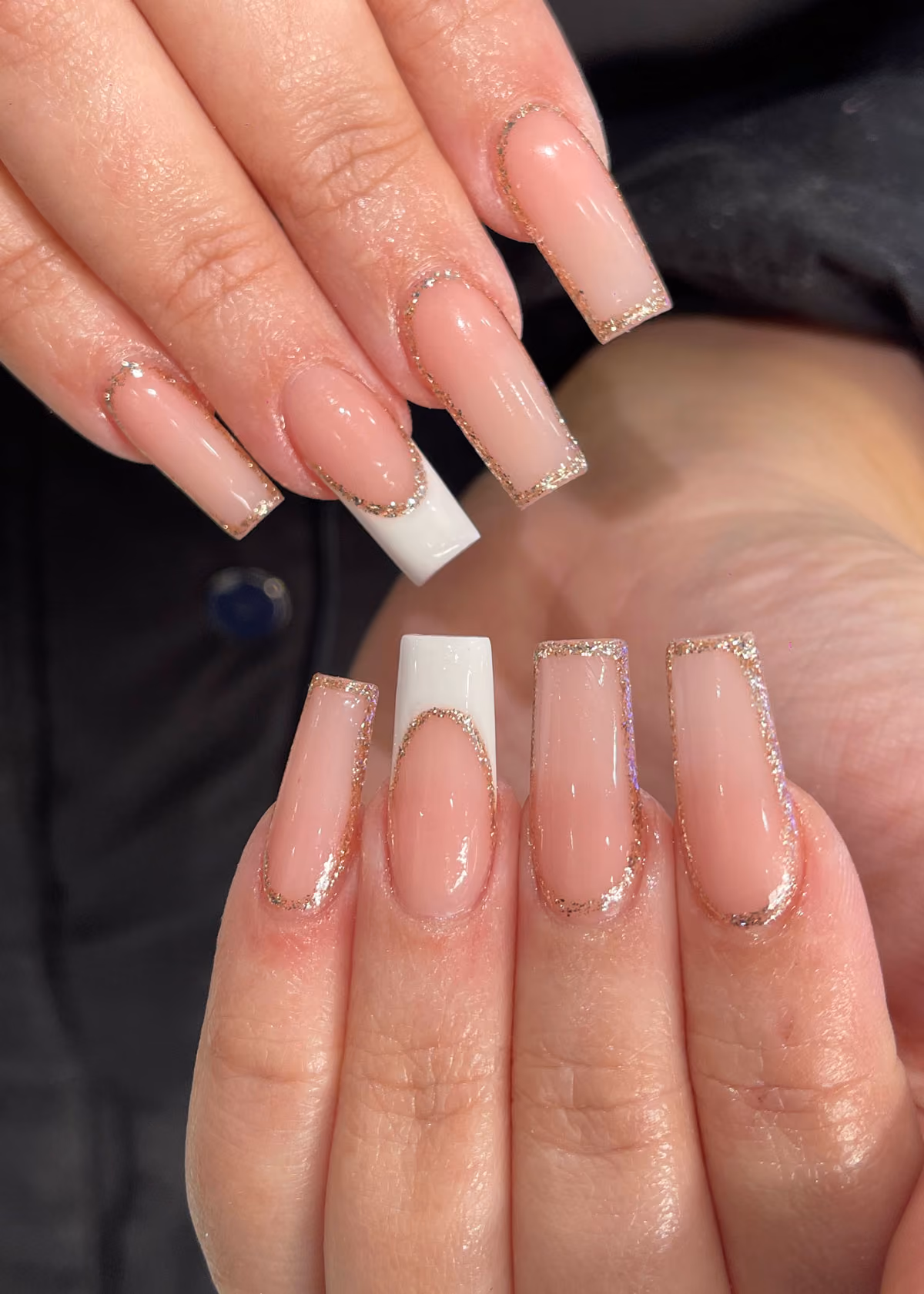 Long square acrylic nails with white French tips and a glitter outline